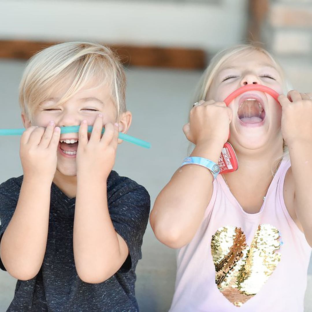 Child drinking from a cup with a soft, flexible GoSili silicone straw