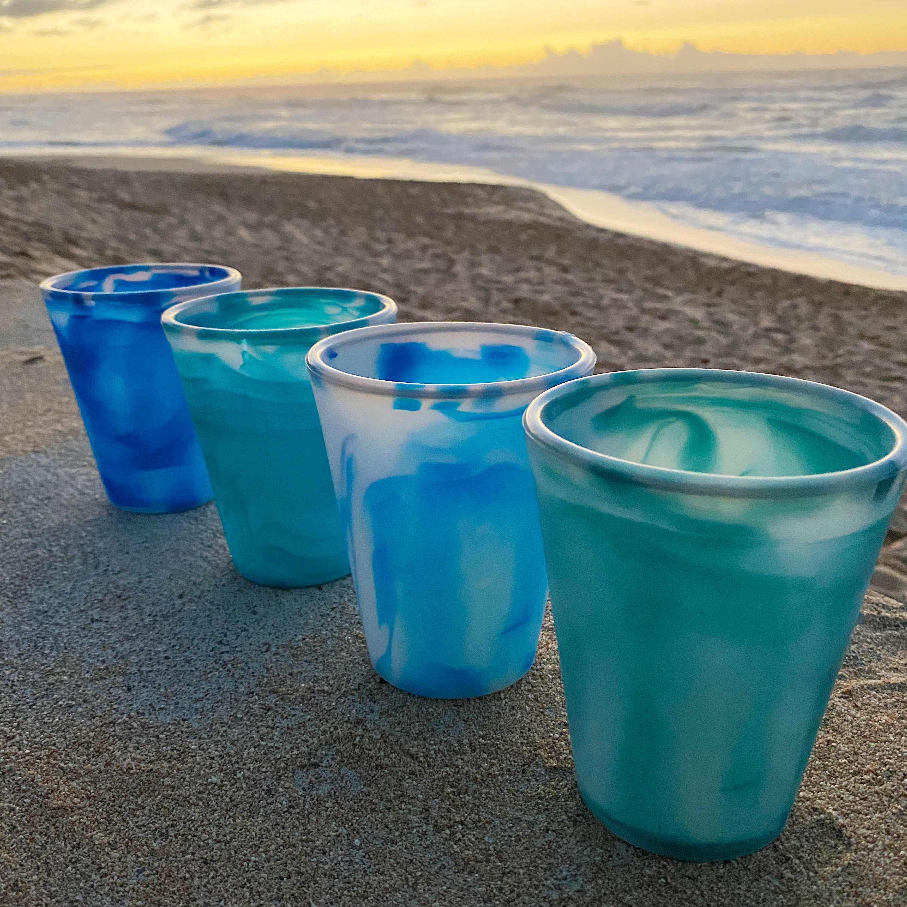 Individually unique GoSili Ocean Cups, featuring water-inspired patterns.
